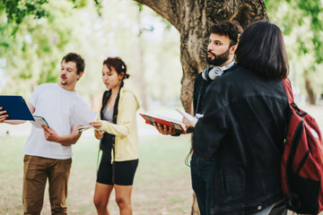A group of diverse students consult with their professor outdoors in a park. The image captures a...