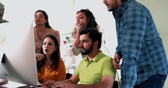 Indian Asian young business professionals startup partners working on crucial project on computer in cozy office, suddenly feeling disappointed, sad, upset as they face unexpected failure or setback