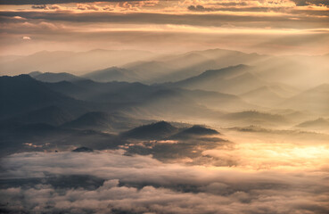 Sunrise shining on layers mountain with foggy in the valley at national park