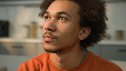 Close up portrait calm serious African American ethnic guy male man looking away to side look at camera face healthy pensive think skin medicine facial expression at home boyfriend homeowner husband