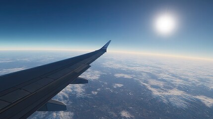 Obraz premium A beautiful and crisp shot of an airplane wing in flight, with the bright blue sky stretching out in all directions.