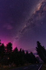Milky way and Aurora australis over the forest on the road in rural scene at New Zealand