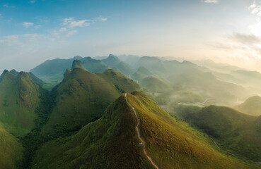 Scenery of Ba Guang grass hill, Mountain range with fog and villager bringing horse to graze on the mountain in the morning