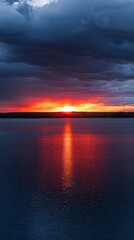Fototapeta premium Fiery Sunset over Calm Lake Dramatic Sky