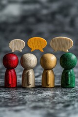 Wooden figures with speech bubbles symbolizing communication and dialogue