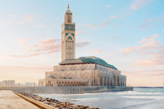 Hassan II Mosque overlooking the Atlantic Ocean in Casablanca, Morocco, with beautiful sunset colors illuminating the sky