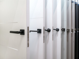 A set of interior doors with different types of handles and locks. Exhibition sale in the store