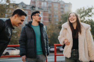Three young adults joyfully interacting and enjoying their time together in a city setting.
