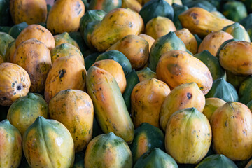 A pile of ripe and unripe mangoes