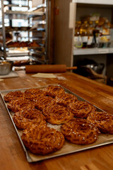 A Tray of Freshly Baked Pastries Exuding Warmth and Aroma in a Cozy Rustic Bakery