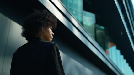 Businesswoman walking through modern cityscape