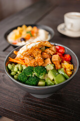Salad bowl with broccoli, edamame, tofu, tempeh and fried egg. A delicious healthy meal with vegetables and nutritious protein