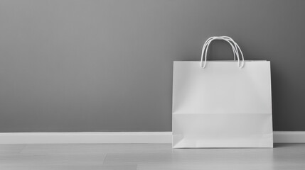 White Shopping Bag Against Gray Wall