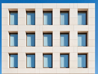 Fototapeta premium Modern hotel facade with geometric window arrangement and soft curtains, showcasing clean architectural design