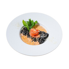 Gourmet black pasta with tomato and spinach a close-up food photography
