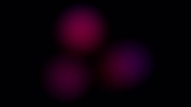 Multicolored shimmers of three circles on a black screen. The effect of flickering neon blue and pink lanterns in 4K with an alpha channel. Bruises concept for overlaying on a clip.