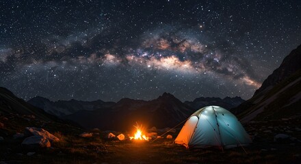 Camping under Milky Way stars with bonfire in the mountains