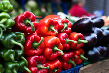 Pile of bell peppers displayed on market counter