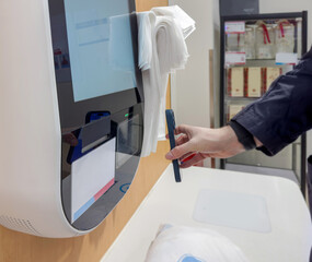Self-checkouts or self-service checkouts,man paying for the purchases  in supermarkets