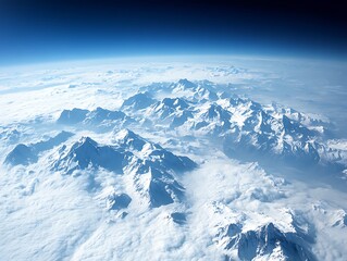 Fototapeta premium Majestic aerial vista of snow-capped mountains piercing through cloud layers