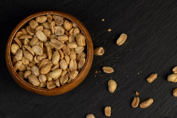 fried yellow peanuts with a little salt on the table