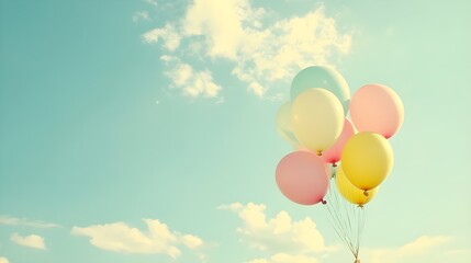 Group of Colorful Balloons Rising Into a Bright Sky.