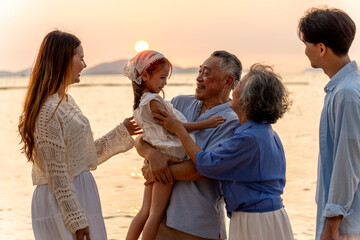 Happy family beach vacations.Group of multi generation family little girl with parents and...