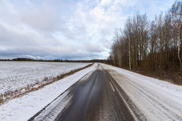 a dirty slippery road in winter after a snowfall