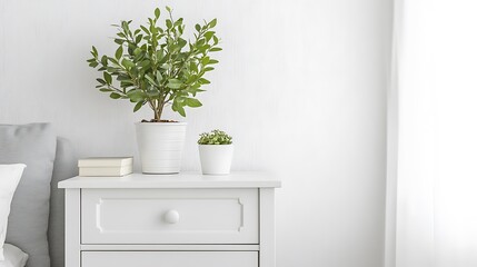 Serene Bedroom Decor: White Nightstand with Greenery