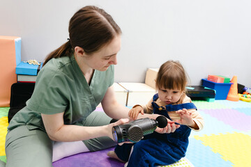 Massage gun stimulates neuroplasticity in little girl patient of rehabilitation center and improves...