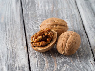 Walnut with shell on wooden background.