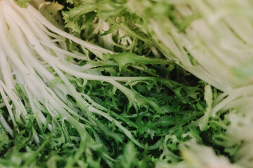 Fresh greens and lettuce at small local urban market. Organic produce on sale at outdoor farmer...