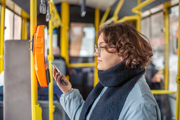 Young woman paying for public transport. Public transport.