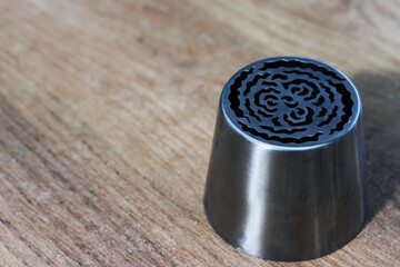 Tip for making marshmallow tulips. Pastry tip made of metal. Close-up view.