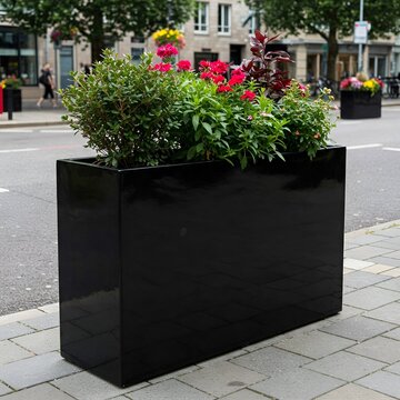 Black rectangular modern fiberglass planter on the street