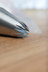 Pastry tip made from stainless steel. For making marshmallows. Plastic pastry bag included. Close-up.