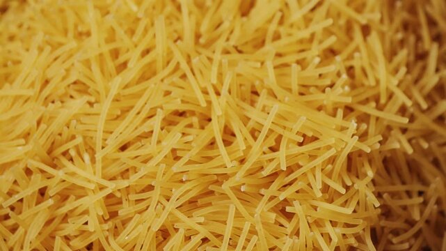 Yellow vermicelli close up footage. Texture of raw pasta. Side dishes concept. High quality 4k footage