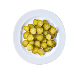 chopped pickled cucumbers in a white plate isolated on a white background, top view.
