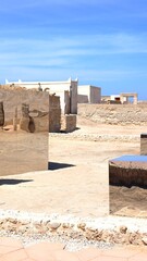 Large mirrored cubes are juxtaposed against the backdrop of traditional arabian architecture in al...