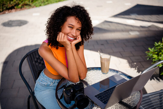 Photo of young girl dreamy cute photographer sit cafe table wear colorful outfit walk park sunlight spring weather travel weekend outside