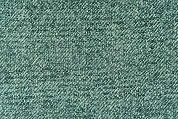 Texture of dense green fabric for tailoring. Canvas. Textile. Material
