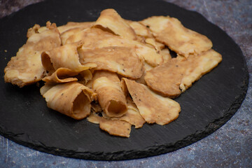 Seitan: vegan meat alternative made with vital wheat gluten, sliced on slate board