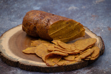 Vegan silced seitan on wooden board