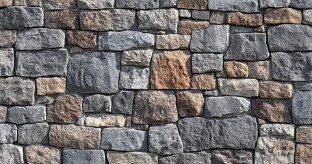 Obraz premium A close-up view of a stone wall made of variously shaped and colored stones, showcasing a rustic and textured appearance.