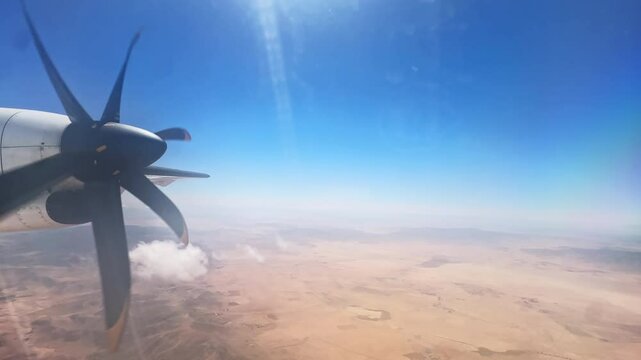 Scenic Flight Over Dry Moroccan Fields Seen Through Plane Window