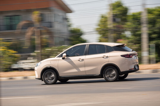 Nakhonsawan, Thailand - Jan, 2025: NETA V-II, A pinkish white car to speed running on the highway, on January 3, 2025, at Nakhon Sawan, Thailand.