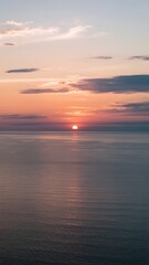 Ocean sunset with vibrant gradient sky and calm reflective water