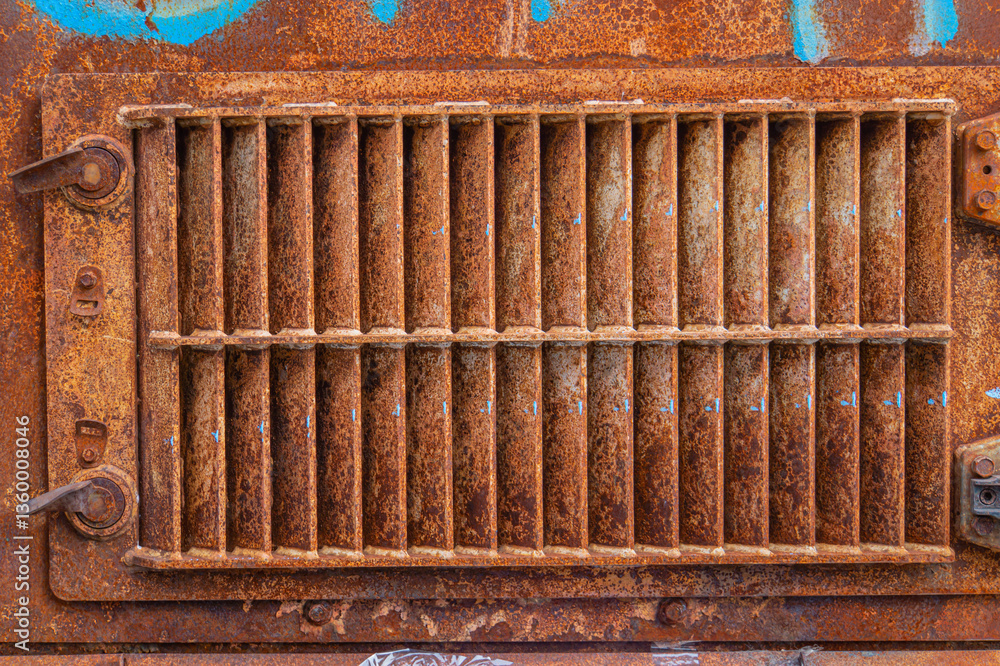 Poster close-up image of an old, rusty metal grating with multiple parallel bars, likely used for drainage 