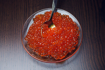 Delicious salmon roe on a white plate, perfect as an appetizer or gourmet brunch dish