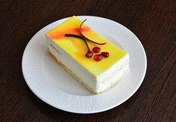 Delicious yellow cake with white cream and chocolate garnish